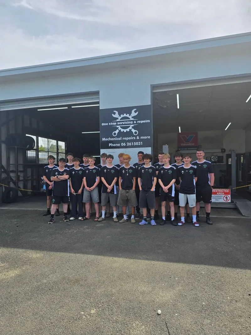 The Thistle Under 19 football squad lined up outside the One Stop workshop